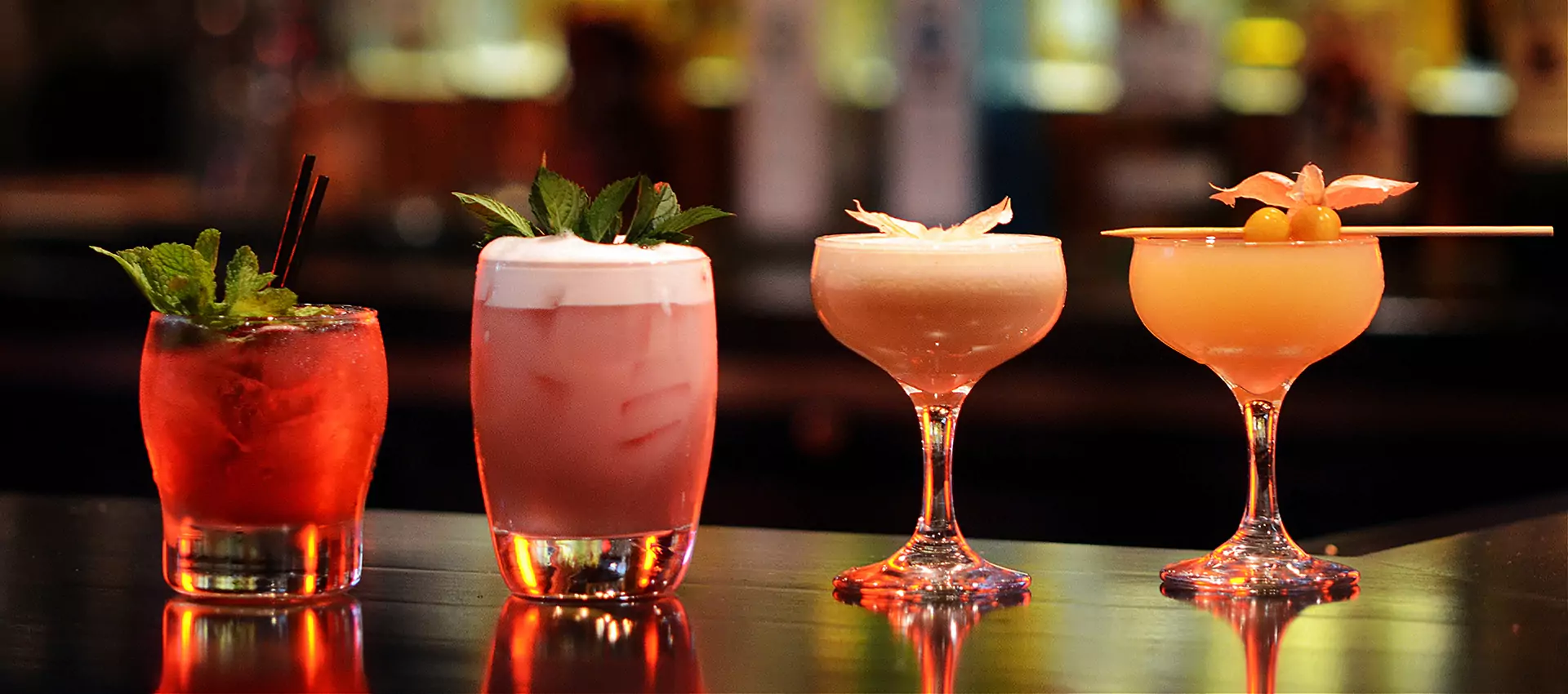 Four signature cocktails lined up on a Barstylez bar