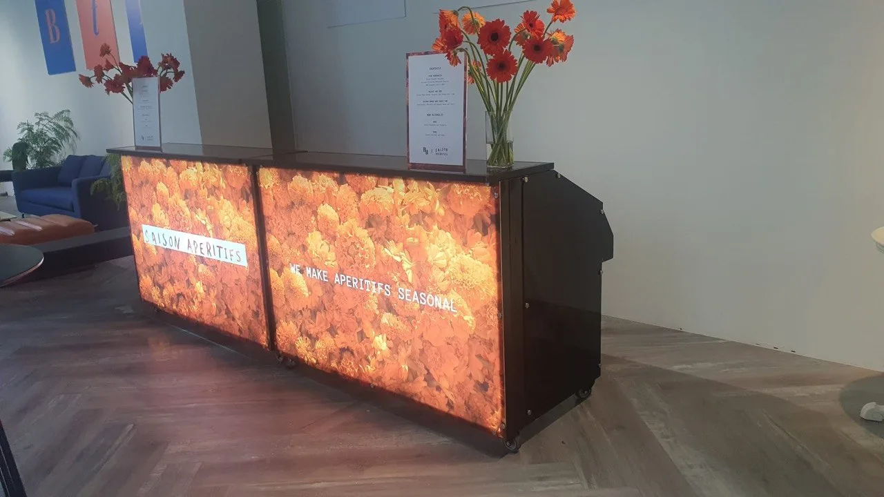 Barstylez LED bar counter with glowing colour-changing floral panels at a Saison Aperitifs event